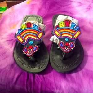 Hand beaded leather flip flops.
